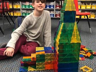 boy with magnetic tower